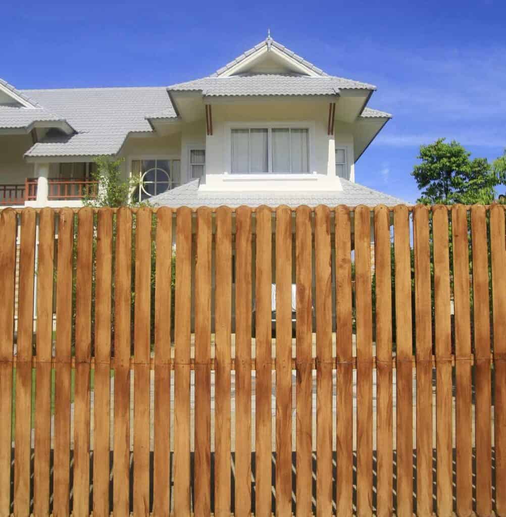 House Behind High Fence. There's More Than 2 Sides Of The Simple Neighborhood Fence