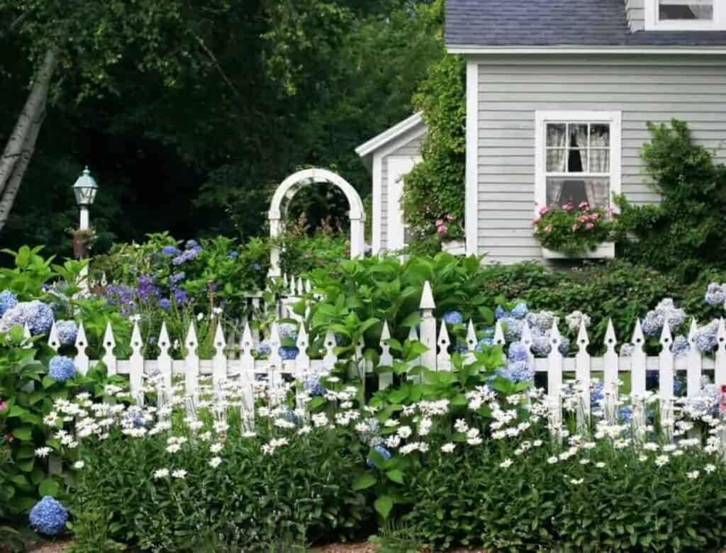 House With White Picket Fence. There's More Than 2 Sides Of The Simple Neighborhood Fence